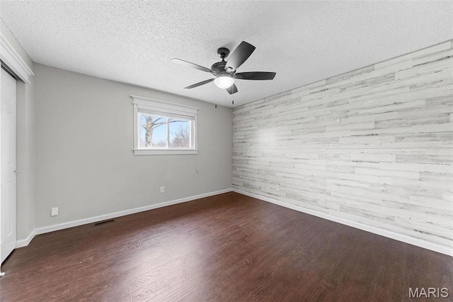 655 Lakewood Dr, Lake St Louis, MO 63367 - unfurnished bedroom with baseboards, a closet, wood finished floors, a textured ceiling, and ceiling fan