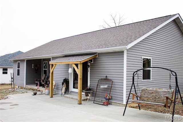 1303 W Coffman St, Salem, MO 65560 - back of property featuring a shingled roof and a patio area