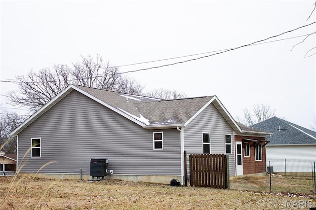1303 W Coffman St, Salem, MO 65560 - view of home's exterior featuring cooling unit, fence, and roof with shingles