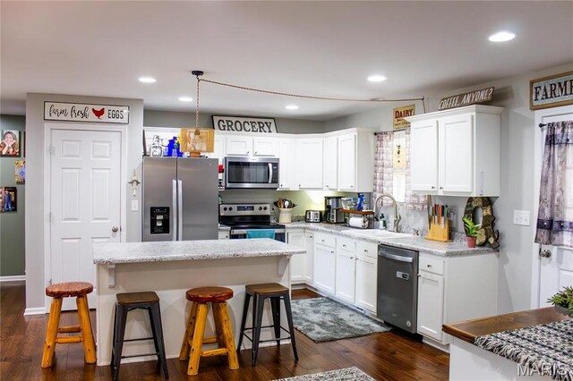 1303 W Coffman St, Salem, MO 65560 - kitchen featuring appliances with stainless steel finishes, a sink, white cabinets, a center island, and recessed lighting