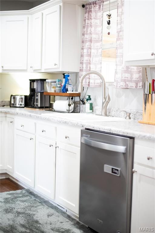 1303 W Coffman St, Salem, MO 65560 - kitchen featuring stainless steel dishwasher, white cabinetry, a sink, light stone countertops, and wood finished floors