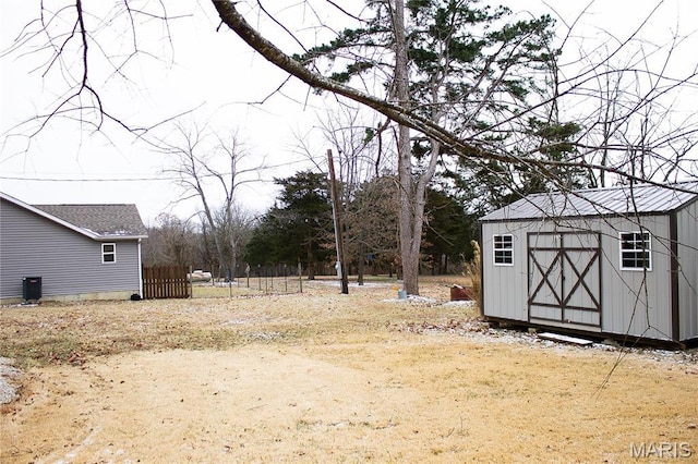 1303 W Coffman St, Salem, MO 65560 - view of yard featuring a shed, an outbuilding, fence, and central AC unit