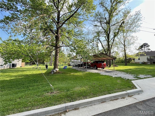 1303 W Coffman St, Salem, MO 65560 - view of grassy yard featuring a detached carport and driveway