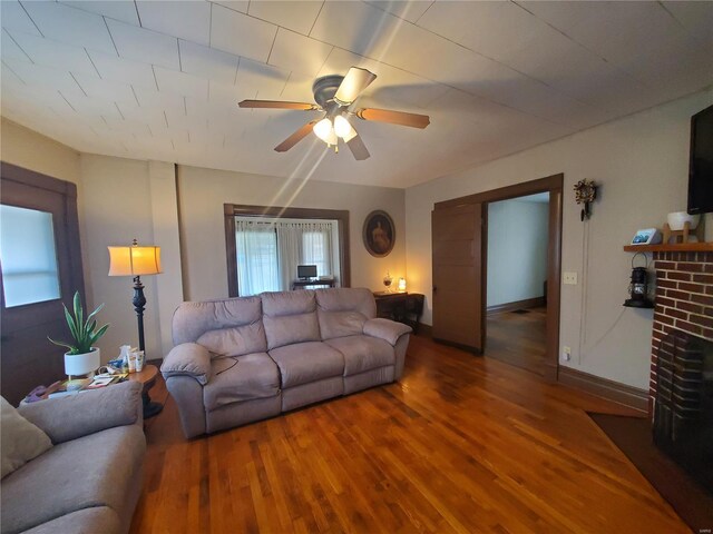 508 S Grand Ave, Houston, MO 65483 - living room with wood finished floors, a ceiling fan, a fireplace, and baseboards