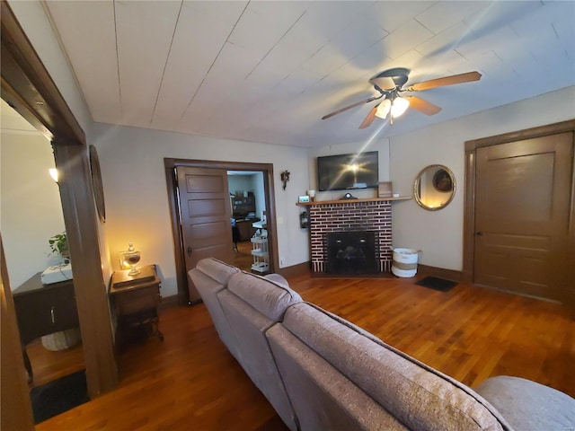 508 S Grand Ave, Houston, MO 65483 - living area featuring wood finished floors, a ceiling fan, a fireplace, and baseboards