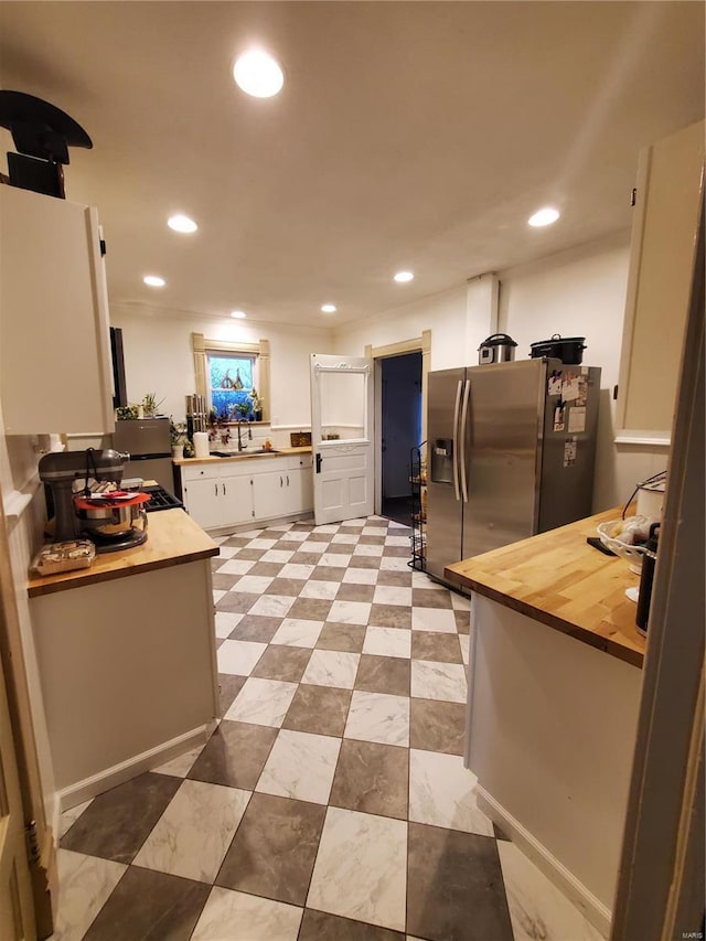 508 S Grand Ave, Houston, MO 65483 - kitchen featuring stainless steel fridge, white cabinets, butcher block countertops, a sink, and recessed lighting