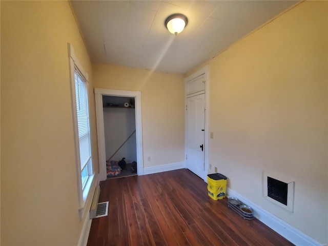 508 S Grand Ave, Houston, MO 65483 - unfurnished bedroom with dark wood-type flooring, baseboards, and multiple windows