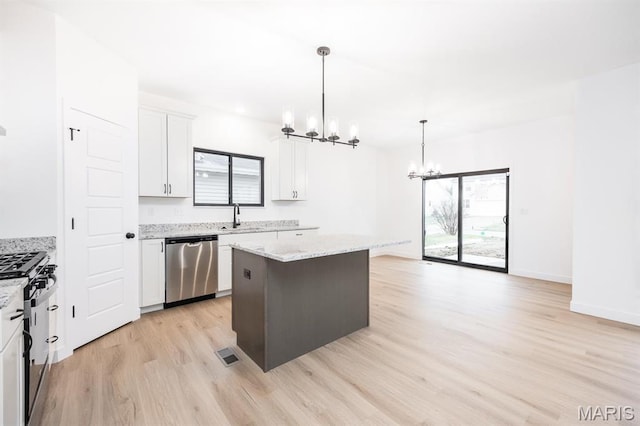 108 Chickasaw Ln, Ofallon, IL 62269 - kitchen featuring a chandelier, stainless steel dishwasher, black range with gas stovetop, light wood-style flooring, and a kitchen island