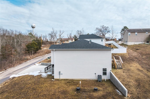 21779 Lomax Dr, Waynesville, MO 65583 - view of property exterior featuring stairway, central AC, and fence