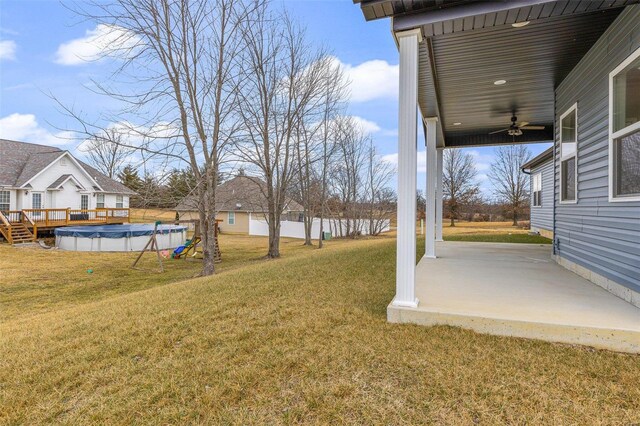 725 Deerfield Ln, Farmington, MO 63640 - view of grassy yard with a ceiling fan and a wooden deck