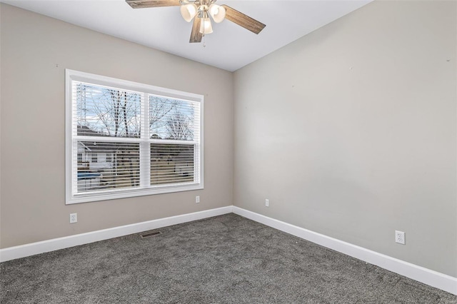 725 Deerfield Ln, Farmington, MO 63640 - spare room featuring ceiling fan, dark colored carpet, and baseboards