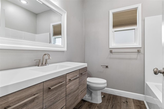 725 Deerfield Ln, Farmington, MO 63640 - full bathroom with baseboards, wood finished floors, toilet, and vanity