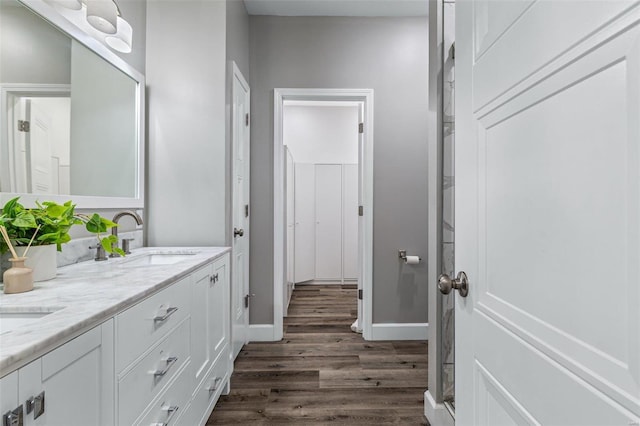725 Deerfield Ln, Farmington, MO 63640 - bathroom with wood finished floors, baseboards, and double vanity