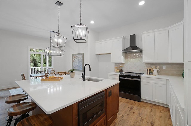 128 Valley Brooke Ct Unit 3Sjm, Washington, MO 63090 - kitchen featuring wall chimney range hood, electric range oven, built in microwave, a sink, and a chandelier