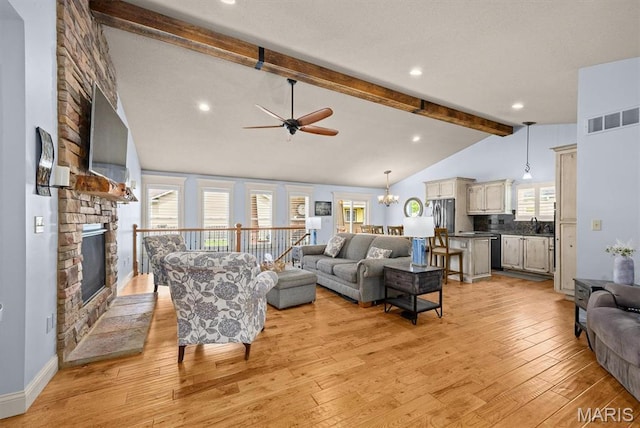 2016 Richview Dr, Saint Jacob, IL 62281 - living area featuring a ceiling fan, light wood-style flooring, a chandelier, and a stone fireplace