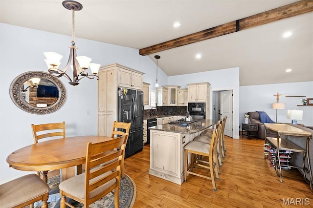 2016 Richview Dr, Saint Jacob, IL 62281 - kitchen with black appliances, cream cabinets, a center island, a chandelier, and decorative backsplash