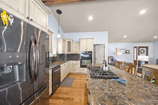 2016 Richview Dr, Saint Jacob, IL 62281 - kitchen with stainless steel appliances, cream cabinets, light wood-type flooring, backsplash, and pendant lighting