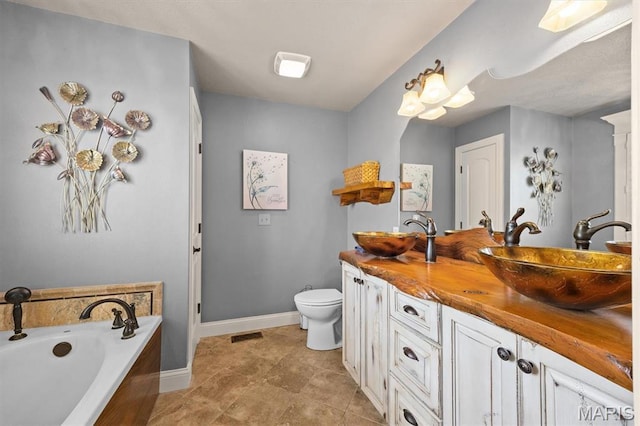 2016 Richview Dr, Saint Jacob, IL 62281 - full bath with baseboards, toilet, double vanity, a bath, and tile patterned flooring