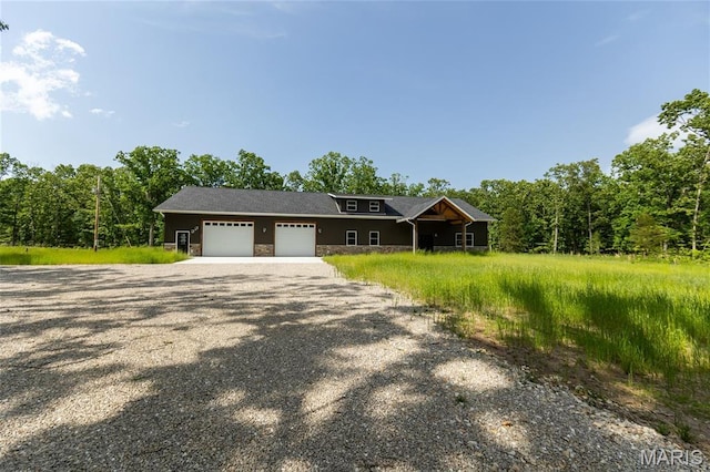 20167 County Road 7300, Newburg, MO 65560 - view of front of property featuring stone siding, gravel driveway, and an attached garage