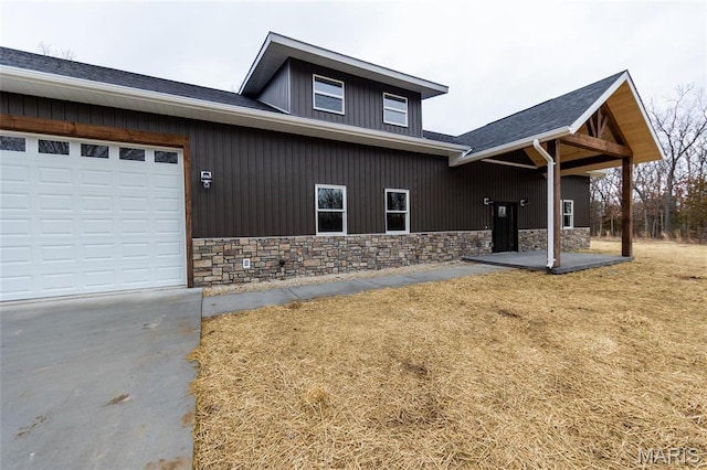 20167 County Road 7300, Newburg, MO 65560 - view of front of home with stone siding, concrete driveway, and an attached garage