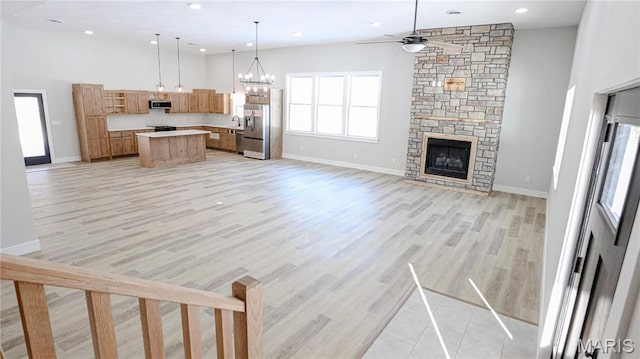 20167 County Road 7300, Newburg, MO 65560 - unfurnished living room with ceiling fan, light wood-style floors, baseboards, a stone fireplace, and recessed lighting