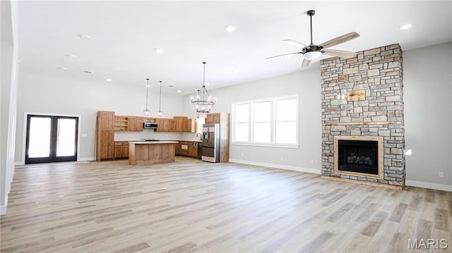 20167 County Road 7300, Newburg, MO 65560 - kitchen featuring open floor plan, ventilation hood, brown cabinets, stainless steel refrigerator with ice dispenser, and a kitchen island