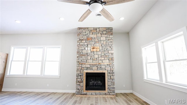 20167 County Road 7300, Newburg, MO 65560 - unfurnished living room with healthy amount of natural light, light wood-style flooring, a stone fireplace, ceiling fan, and recessed lighting