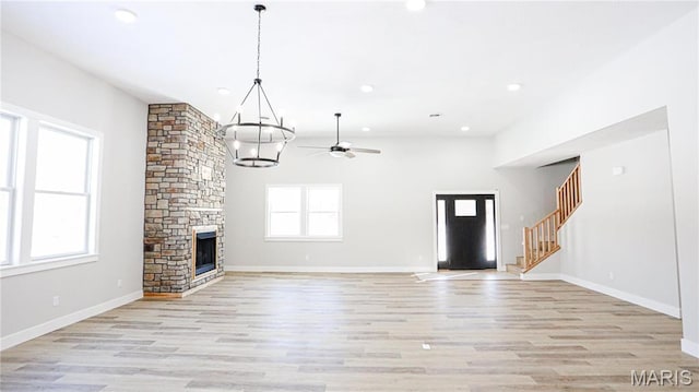 20167 County Road 7300, Newburg, MO 65560 - unfurnished living room featuring a chandelier, ceiling fan, light wood finished floors, stairs, and recessed lighting