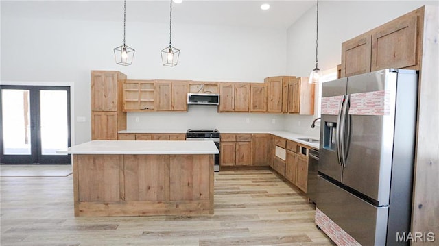 20167 County Road 7300, Newburg, MO 65560 - kitchen with appliances with stainless steel finishes, a high ceiling, light wood-type flooring, a sink, and light countertops
