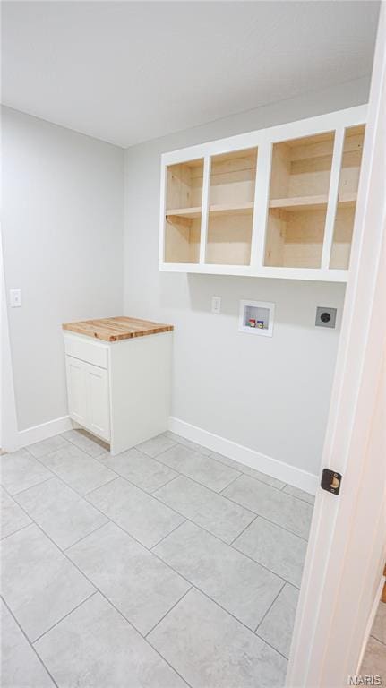 20167 County Road 7300, Newburg, MO 65560 - washroom with hookup for an electric dryer, washer hookup, light tile patterned floors, baseboards, and cabinet space
