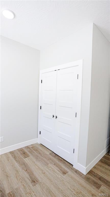 20167 County Road 7300, Newburg, MO 65560 - unfurnished bedroom with light wood-type flooring, baseboards, and a closet