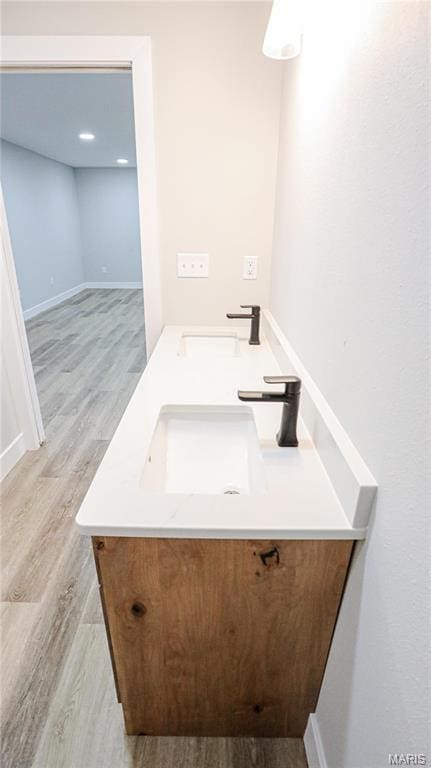 20167 County Road 7300, Newburg, MO 65560 - bathroom with double vanity, wood finished floors, and baseboards