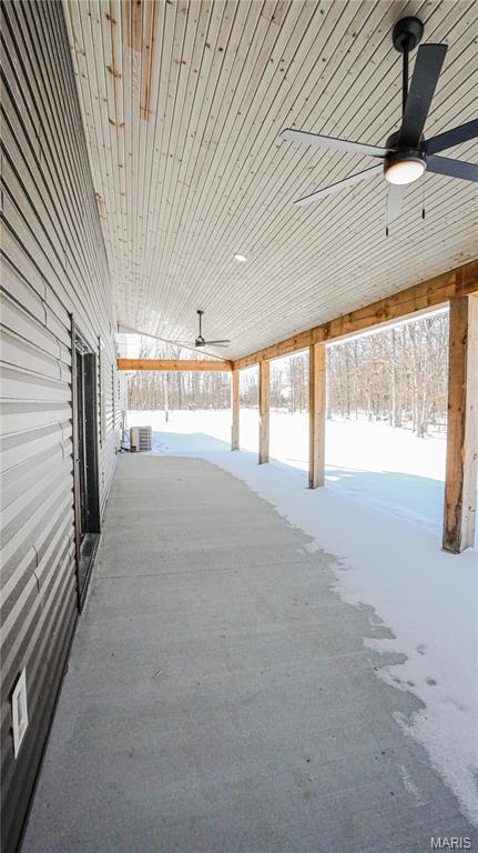 20167 County Road 7300, Newburg, MO 65560 - snow covered garage with ceiling fan and central AC unit