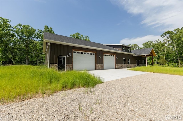 20167 County Road 7300, Newburg, MO 65560 - view of front facade featuring stone siding, driveway, a garage, and board and batten siding