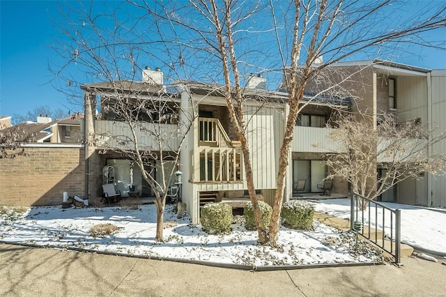632 Coeur De Royale Dr Unit C, Saint Louis, MO 63141 - snow covered back of property with a chimney and fence