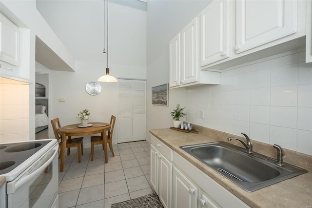 632 Coeur De Royale Dr Unit C, Saint Louis, MO 63141 - kitchen with a sink, white range with electric cooktop, white cabinets, light tile patterned floors, and backsplash