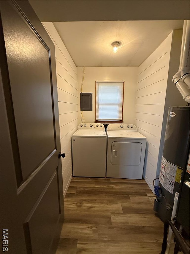 15 W Bibb Dr, Bowling Green, MO 63334 - laundry room featuring separate washer and dryer, gas water heater, wood walls, electric panel, and dark wood-style flooring