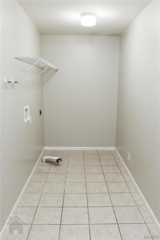 20981 Lacombe Rd, Waynesville, MO 65583 - laundry area featuring washer hookup, light tile patterned flooring, hookup for an electric dryer, and baseboards