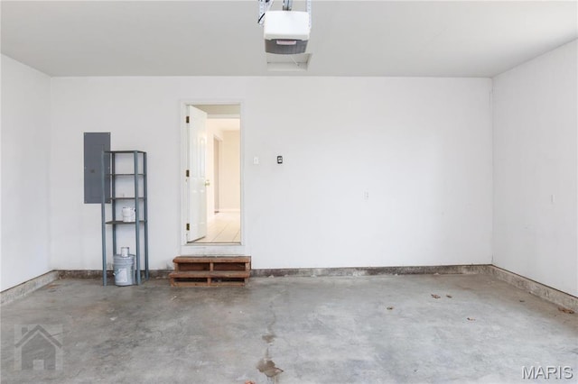 20981 Lacombe Rd, Waynesville, MO 65583 - garage featuring a garage door opener, electric panel, and baseboards