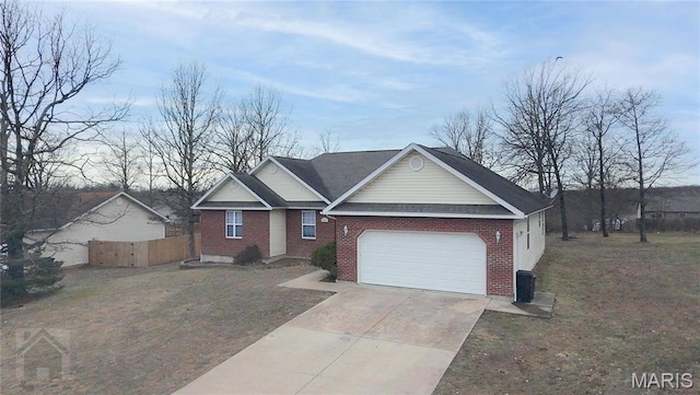 20981 Lacombe Rd, Waynesville, MO 65583 - view of front facade featuring brick siding, an attached garage, and concrete driveway
