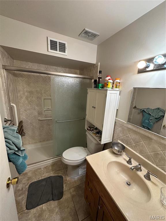 4290 Chateau De Ville Dr Unit G, Saint Louis, MO 63129 - bathroom featuring a shower stall, toilet, vanity, and tile patterned floors