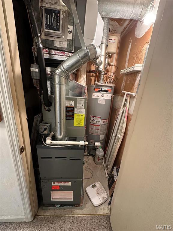 4290 Chateau De Ville Dr Unit G, Saint Louis, MO 63129 - utility room featuring gas water heater and heating unit