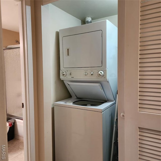 1239 Creve Coeur Crossing Ln Unit C, Chesterfield, MO 63017 - laundry room featuring stacked washer and clothes dryer and tile patterned flooring
