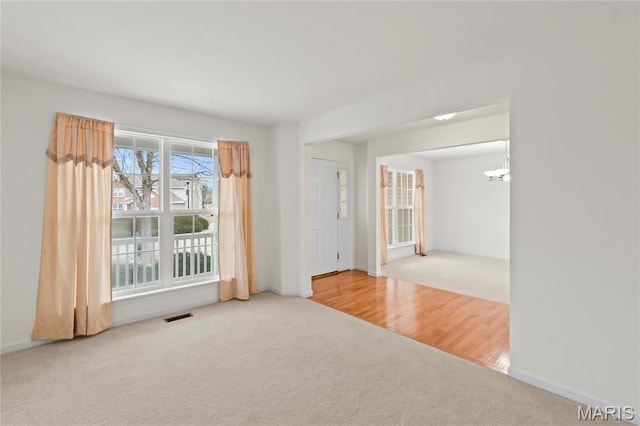 1 Ashbury Crossing Ct, Florissant, MO 63034 - carpeted spare room with a chandelier and baseboards