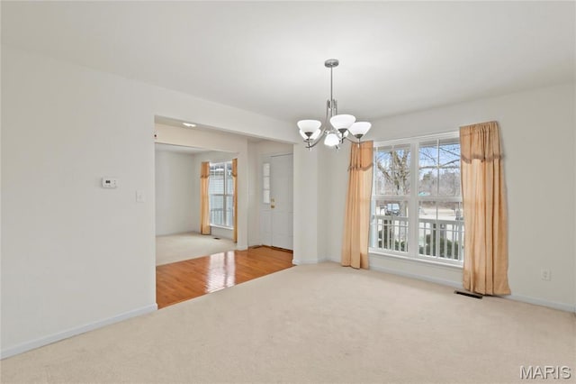 1 Ashbury Crossing Ct, Florissant, MO 63034 - carpeted empty room with a chandelier and baseboards
