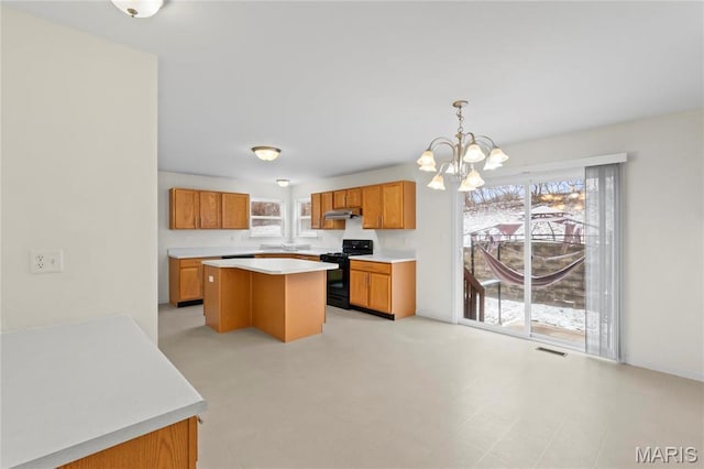 1 Ashbury Crossing Ct, Florissant, MO 63034 - kitchen with black range with gas cooktop, a chandelier, light countertops, and healthy amount of natural light