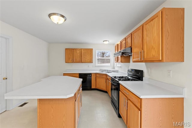 1 Ashbury Crossing Ct, Florissant, MO 63034 - kitchen with black appliances, under cabinet range hood, light countertops, and a sink