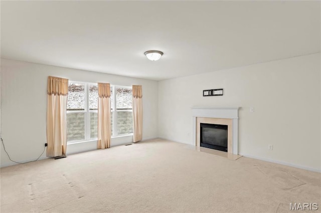 1 Ashbury Crossing Ct, Florissant, MO 63034 - unfurnished living room with carpet flooring, a glass covered fireplace, and baseboards