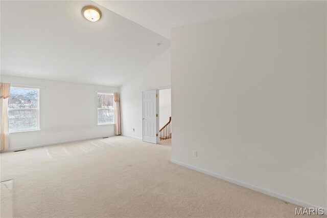 1 Ashbury Crossing Ct, Florissant, MO 63034 - carpeted empty room featuring baseboards and high vaulted ceiling