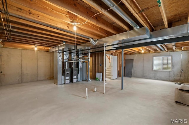 1 Ashbury Crossing Ct, Florissant, MO 63034 - basement with heating unit, stairway, and gas water heater